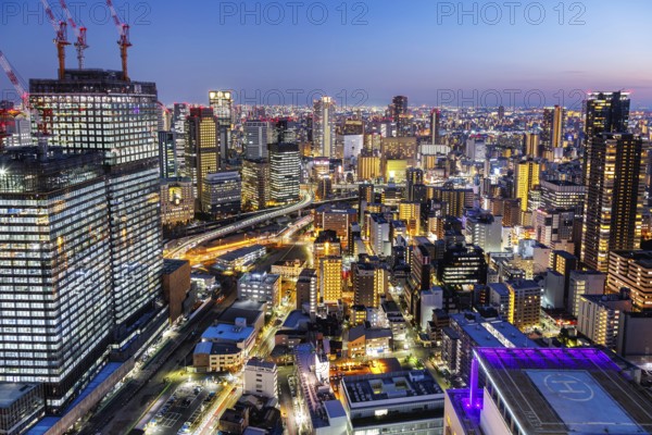 Osaka city from above with the skyline skyscrapers at night in Osaka, Japan, Asia
