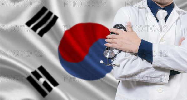 Doctor with stethoscope on South Korean flag. Doctor with crossed arms on South Korean flag. Medical health and care on South Korean flag