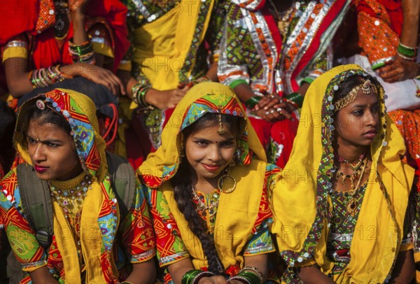 PUSHKAR, INDIA, NOVEMBER 21, 2012: Unidentified Rajasthani girls in traditional outfits prepare for dance perfomance at annual camel fair Pushkar Mela in Pushkar, Rajasthan, India, Asia