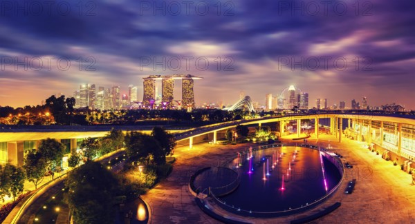 Singapore travel tourism concept, vintage retro effect filtered hipster style image of panorama of Singapore skyline illumintaed in the evening twilight