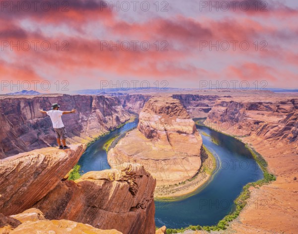 A young man with white shirt and green hat in Horseshoe Bend, Arizona. United States
