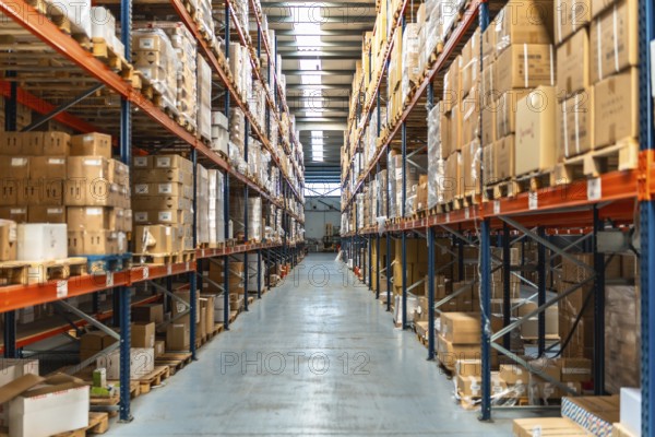 Interior view of an aisle of a distribution warehouse full of packages and no people