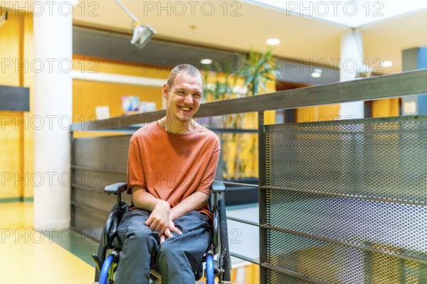 Happy man with cerebral palsy in a modern coworking smiling at camera in the corridor
