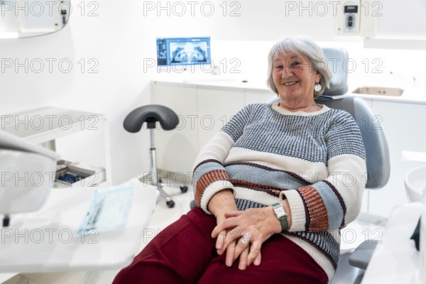 Elderly patient smiling and feeling comfortable during a dental checkup in a bright, modern clinic, highlighting senior oral care