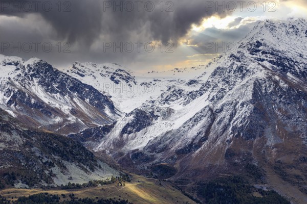 Dark clouds over the snow-covered mountains above Saint Luc, Val d'Anniviers, Valais Alps, Canton Valais, Switzerland, Europe
