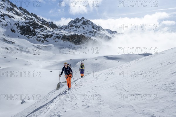 Ski tourers on the Grisons Haute Route, Albula Alps in winter, Rhaetian Alps, Grisons, Eastern Switzerland, Switzerlandm