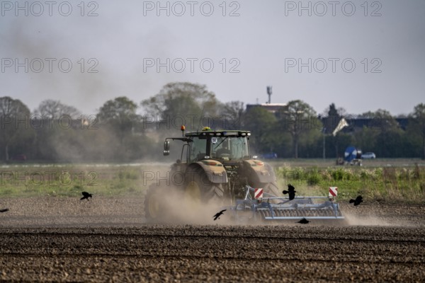 A tractor works a field, due to long dryness in spring, no rain for more than 4 weeks, the fields are dusty, near Kerken, Lower Rhine, North Rhine-Westphalia, Germany, Europe