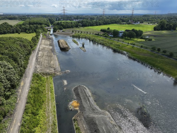 Dortmund / Castrop-Rauxel, North Rhine-Westphalia, Germany, river renaturalisation, renaturation of the Emscher, flood retention basin HRB Mengede. A new floodplain landscape is being created at the Emscher-Auen farm, expanding the area for flood protection during heavy rainfall and for biodiversity. The Emscher, which is currently straightened, will be given curves again and can meander through its new floodplain. Following the construction of a parallel sewer, the Emscher has been completely free of wastewater since 2022. The river was previously an open, above-ground combined sewer with rainwater and wastewater. The A45 motorway in the background, Europe