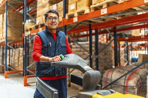 Three quarter length photo of a happy latin man driving hand truck in a distribution warehouse