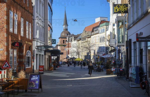 Oldenburg, Lower Saxony, Germany - Historic town centre, here the Lange Straße in the pedestrian zone, behind the Lappan, an old bell tower with a Renaissance dome, a sight in the old town of Oldenburg. The pedestrian zone is characterised by historic buildings, small alleyways, a variety of owner-managed shops and restaurants. On the left the Hof Apotheke