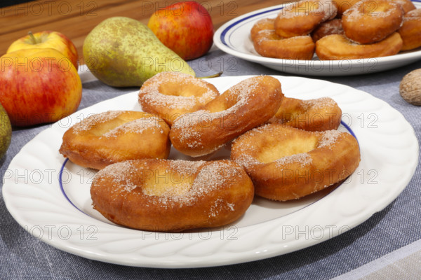 Swabian cuisine, harvest cakes, dessert, dessert, fat baked goods, doughnuts, fried food, lard noodles, arranged on a plate, grandmother's kitchen, regional, home cooking, typical Swabian, classic recipe, traditional cuisine, food photography, autumn atmosphere, apples, pears, nuts, still life, studio, Germany, Europe