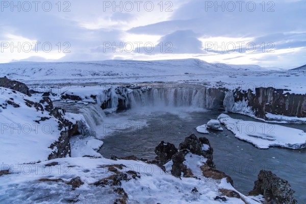 Landscape detail of frozen Godafoss waterfall at sunset in winter, Iceland, Europe
