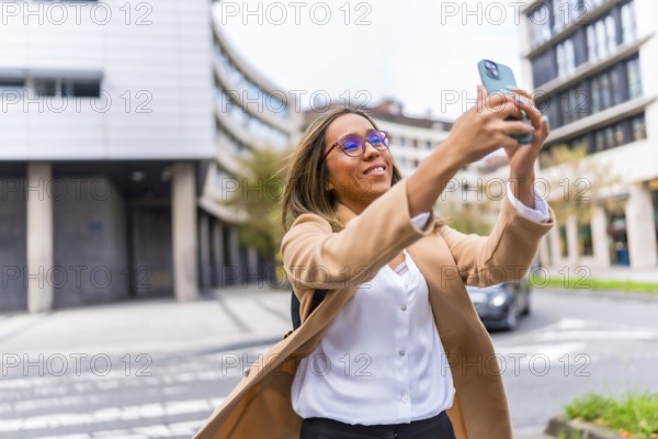 Latin woman visiting a city and taking photos with mobile phone enjoying the day in the city