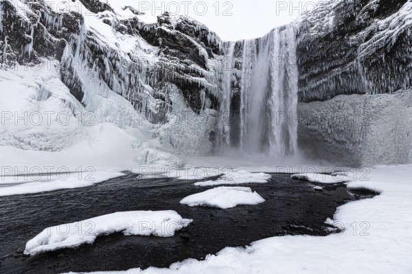 Skogafoss waterfall, snowy and icy rock face, Sudurland, Iceland, Europe