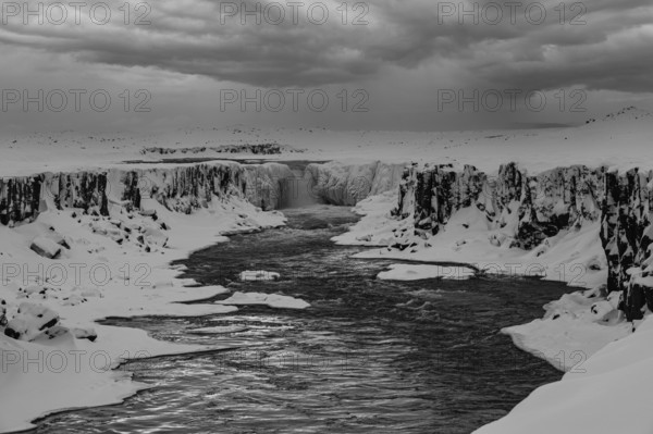 Selfoss waterfall with the river Jökullsa a Fjöllum, icy and snow-covered rock faces and shoreline, black and white photo, Northern Iceland Eyestra, Iceland, Europe