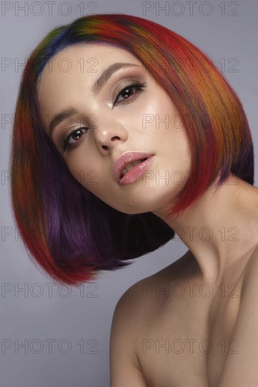 Portrait of beautiful woman with multi-colored hair and creative make up and hairstyle