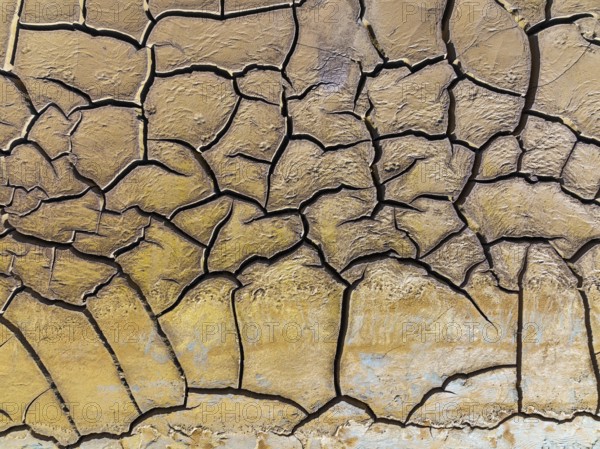 Mineral-rich cracked earth at the bank of the Rio Tinto (Red river), aerial view, drone shot, Huelva province, Andalusia, Spain, Europe