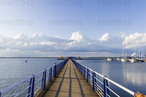 Bärwalder See Landscape Park, post-mining landscape, remnant hole of the Bärwalde open-cast mine, silhouette of the Boxberg power station, Klitten harbour, pier, yachts, Klitten, Saxony, Germany, Europe