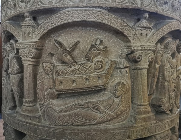 Romanesque baptismal font from 1129 in the former collegiate church of St. Boniface, relief depicting the birth of Jesus, Freckenhorst, Warendorf district, Baden-Württemberg, Germany, Europe