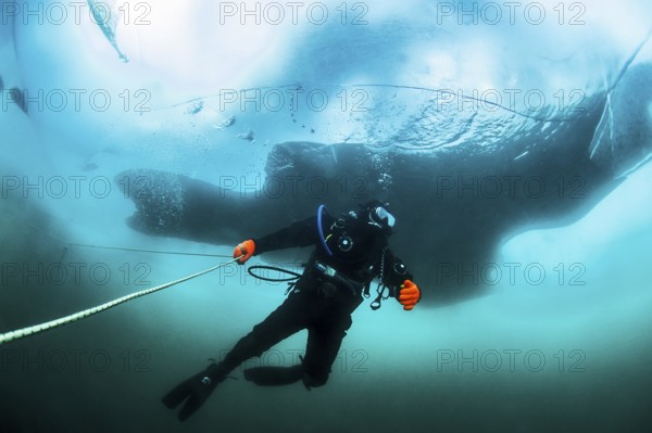 Scuba diver under the ice, Lake Baikal, Olkhon Island, Pribaikalsky National Park, Irkutsk Province, Siberia, Russia, Europe