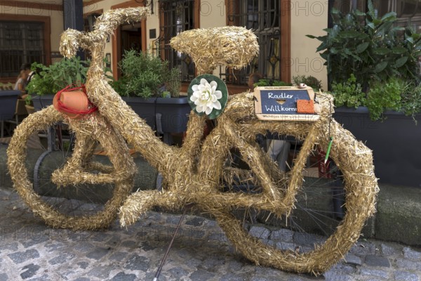 Bicycle wrapped in straw, cyclists welcome, in front of a restaurant, Bamberg, Upper Franconia, Bavaria, Germany, Europe