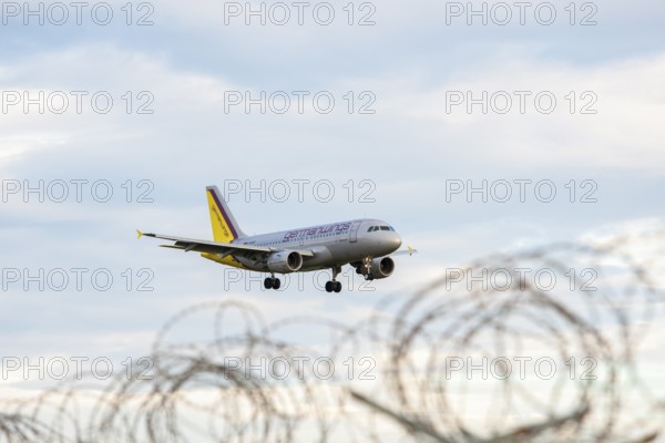 Symbolic image, deportation flights of illegal and delinquent migrants, passenger aircraft, airport, security fence, barbed wire, Germany, Europe