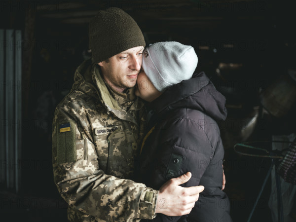 A Ukrainian soldier says goodbye to his woman after a furlough, Hroza, Ukraine, Europe
