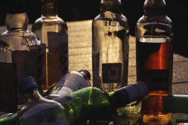Alcohol, glass bottles, atmosphere, backlight, colourful, alcohol problem, empty and partially filled alcohol bottles are illuminated by sunlight