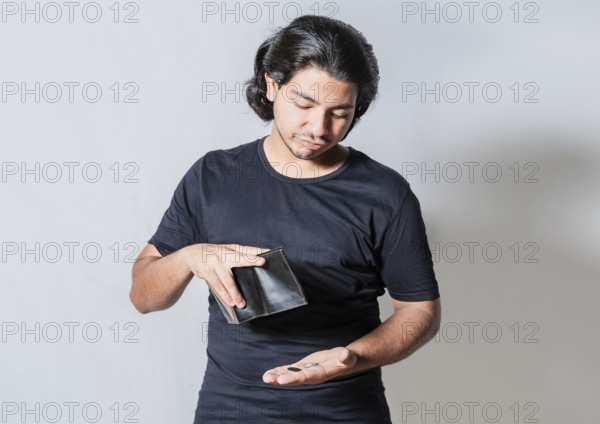 Unhappy man with financial crisis isolated. Person with financial crisis holding wallet. Sad man holding an empty wallet isolated