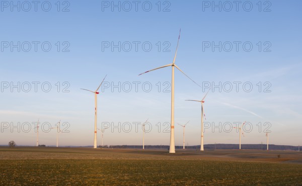Large wind turbines spread across an open field landscape under a bright sky, solar park, near Ulm, Swabian Alb, Baden-Württemberg, Germany, Europe