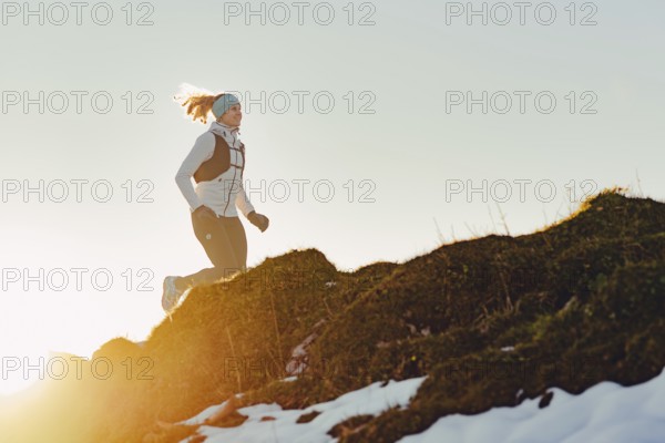 Trail running in autumn on the Jochberg on Lake Walchensee against the wonderful backdrop of the Alps, Bavaria, Germany, Europe