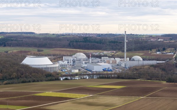 The decommissioned Neckarwestheim nuclear power plant lies in the middle of vast fields and forests under a cloudy sky, Neckarwestheim, Baden-Württemberg, Germany, Europe