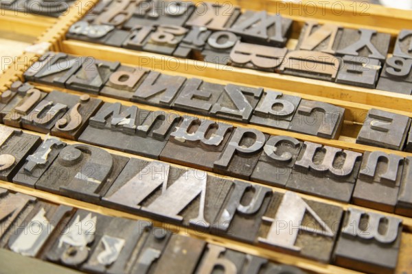 Metal block types letters of an old printing press, UK