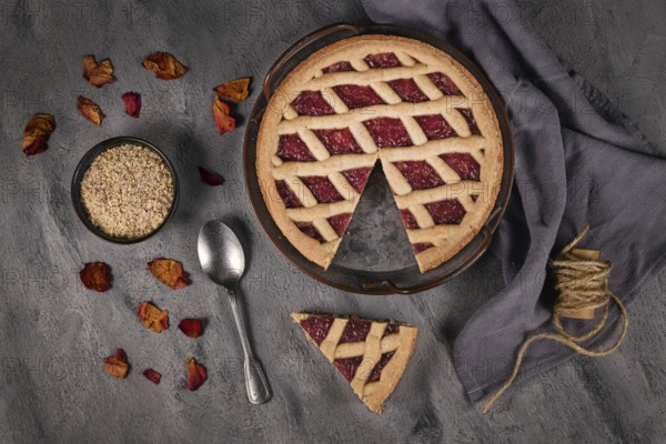 Top view of homemade pie called 'Linzer Torte', a traditional Austrian shortcake pastry topped with fruit preserves and ground nuts with lattice design