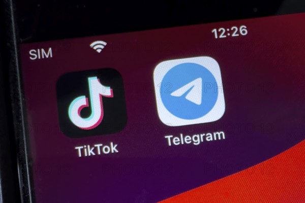 App icons from chat programmes free instant messaging service on the left from China TikTok and on the right Russian-developed messenger Telegram on smartphone, international