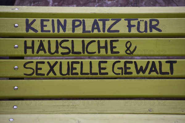 Green bench with the inscription No place for domestic and sexual violence, seen in Burghausen, Bavaria, Germany, Europe