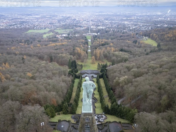 Copper statue of Hercules in Bergpark Wilhelmshöhe with a view over Wilhelmshöhe Palace and Wilhelmshöher Allee to Kassel city centre, Bad Wilhelmshöhe, Kassel, Hesse, Germany, Europe