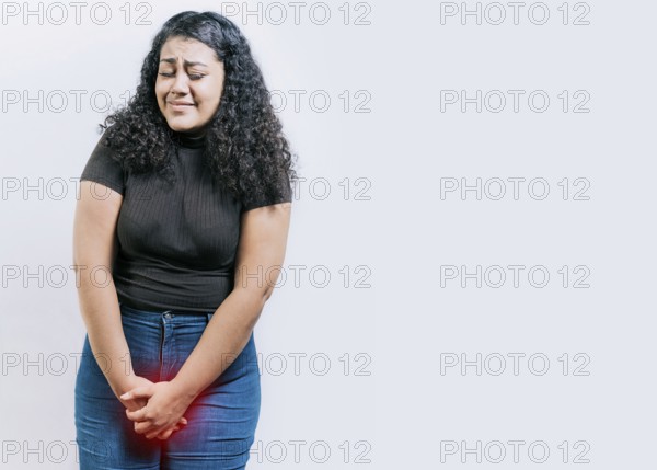 Young woman with urinary problems isolated. Girl with hands on crotch with urinary problems. People with urinary incontinence on white background