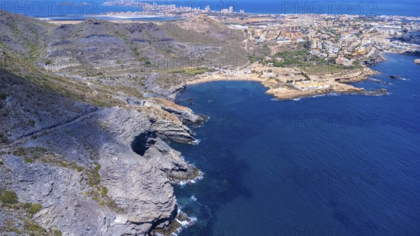 Aerial view of la manga del mar menor with its crystal clear turquoise waters gently lapping against the rocky coastline near cala reona