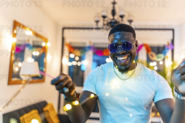 Close-up portrait of a handsome african man laughing dancing in a home night party