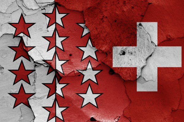 Flags of Valais canton and Switzerland painted on cracked wall