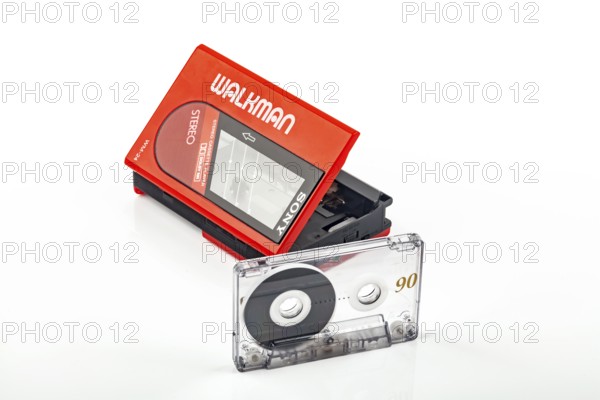 WETZLAR, Germany: 2022-04-16: Beautiful red vintage SONY WALKMAN WM-24 with audio tape over bright background