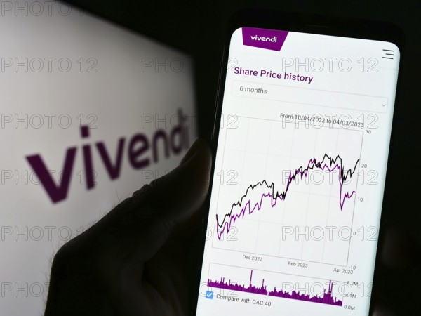 Stuttgart, Germany, 04-04-2023: Person holding cellphone with website of French mass media company Vivendi SE on screen in front of logo. Focus on center of phone display, Europe