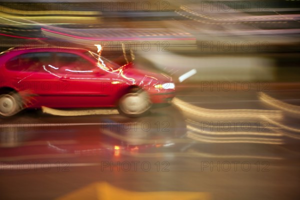 Car moving in rainy night motion blur on light and vehicle