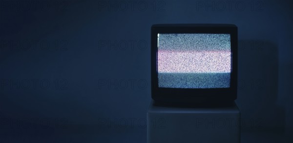 No TV signal on old television with copy space on dark background. Interference, television noise. Glitch Error. Video Damage
