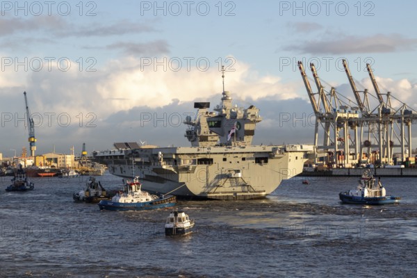 Harbour tug and aircraft carrier HMS Queen Elizabeth, warship of the British Royal Navy on the river Elbe arriving for a NATO exercise in the port of Hamburg, Germany, Europe