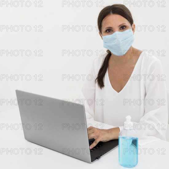 Woman wearing medical mask hand sanitizer