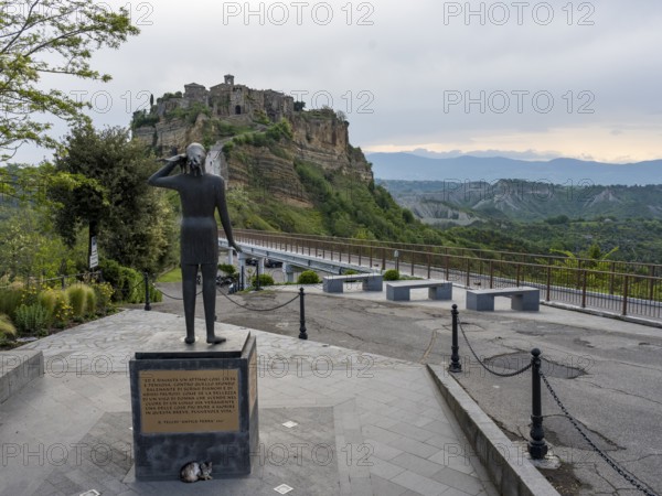Sculpture with a view of the hilltop village of Civita di Bagnoregio, Lazio, Italy, Europe