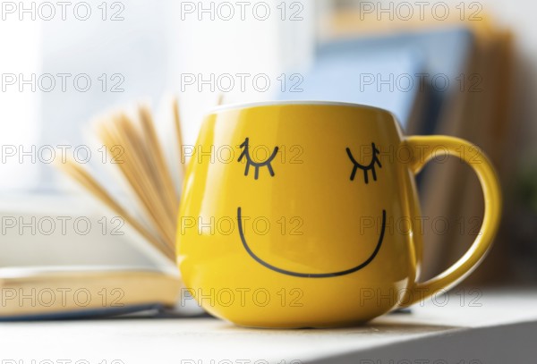 Open book smiley yellow cup