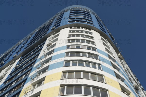 Modern multi-storey residential building on a background of blue sky